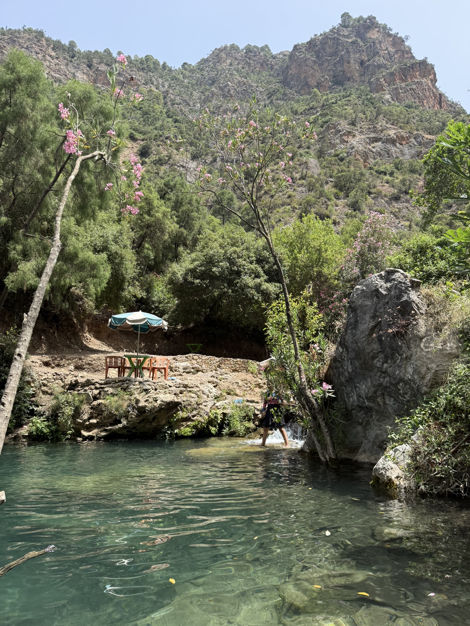 Mountain pool beneath rocky peaks